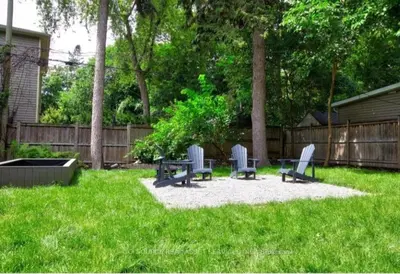 two chairs and a table in a yard at Urban 2-bed apartment in the Beaches in Toronto
