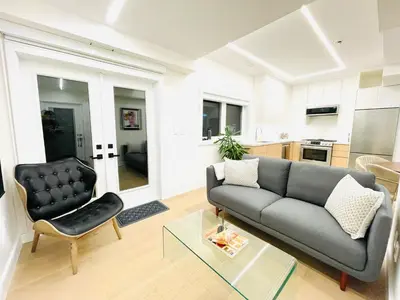 a living room with a couch and a chair at Urban 2-bed apartment in the Beaches in Toronto