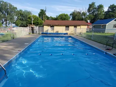 a swimming pool with blue water in a yard at Stoneburg Cove Cottages in Carrying Place