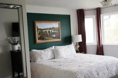a bedroom with a bed and a painting on the wall at Waterfront Boutique Accommodation in PEC - Suite 3 in Belleville