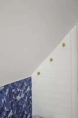 a staircase with white walls and blue and white wallpaper at Queen Suite with Private Ensuite at Fancie's PEC - Suite 1 in Belleville