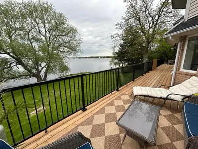 a deck with a view of the water on a house at Queen Suite with Private Ensuite at Fancie's PEC - Suite 1 in Belleville