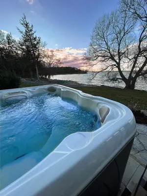 a jacuzzi tub with a view of the water at Queen Suite with Private Ensuite at Fancie's PEC - Suite 1 in Belleville