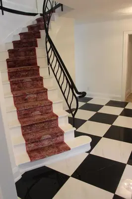a carpet staircase in a house with a checkered floor at 4 Guest Suite with Waterfront Views at Fancie's PEC - Suite 2 in Belleville