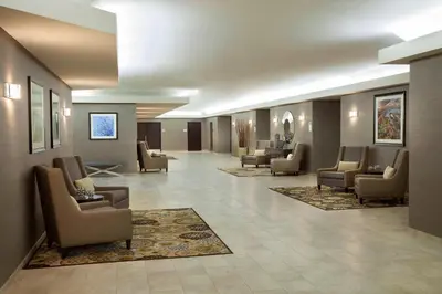 a waiting room with couches and chairs in a lobby at Courtyard by Marriott Toronto Northeast/Markham in Markham