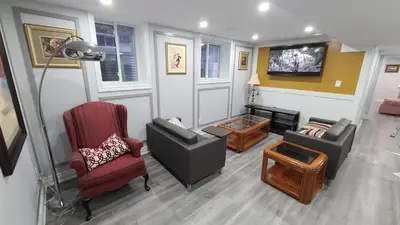 a living room with two chairs and a tv at LUXURY 2-BEDROOMS UNIT WITH WIFI, LDR & PARKING. in Cambridge