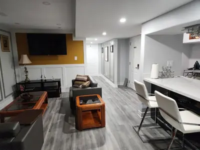a living room with a couch and a piano at LUXURY 2-BEDROOMS UNIT WITH WIFI, LDR & PARKING. in Cambridge