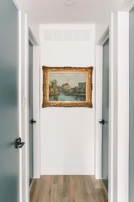 a painting on the wall of a room with two doors at The Old Homestead - Gorgeous backyard right in The Heart of Picton in Picton