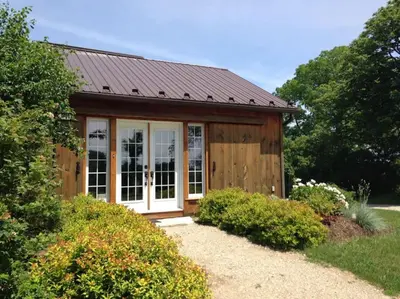a small wooden shed with a metal roof at The Farm Shed Guelph Elora in Guelph