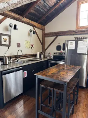 a kitchen with a sink and a refrigerator at The Farm Shed Guelph Elora in Guelph
