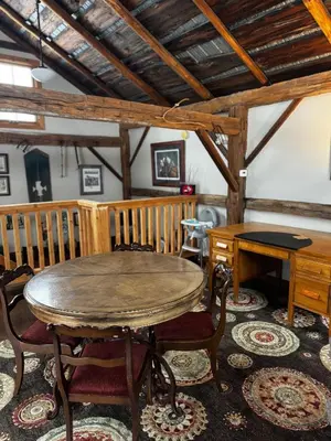 a dining room with a wooden table and chairs at The Farm Shed Guelph Elora in Guelph