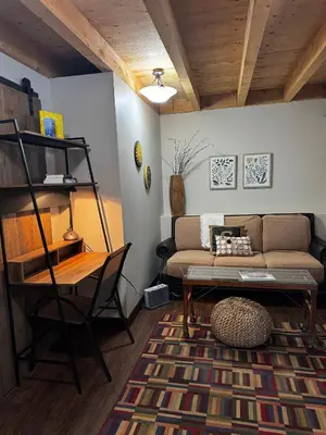 a living room with a couch and a table at The Farm Shed Guelph Elora in Guelph