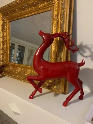 a red statue of a red deer in front of a mirror at Charming Bloor West Retreat in Toronto