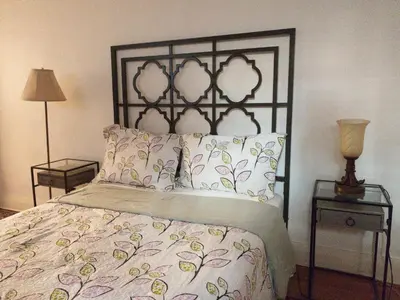 a bedroom with a bed with two tables and a lamp at Charming Bloor West Retreat in Toronto