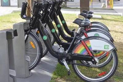 a group of bikes parked in a row with a rainbow at Charming Bloor West Retreat in Toronto