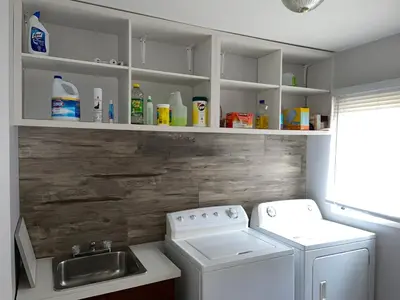 a laundry room with a washer and a sink at Swing Bridge Cottage on Lake Simcoe - Waterfront in Brechin