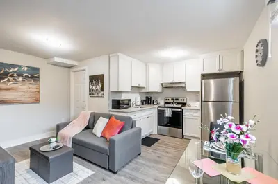 a living room with a couch and a kitchen at 1BR Basement Condo - James Street in Hamilton