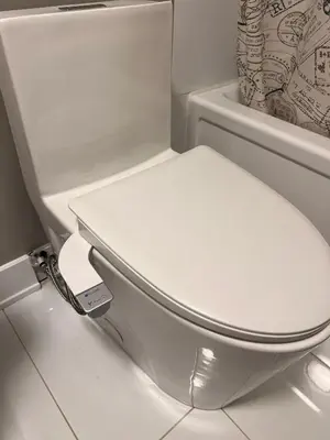 a bathroom with a white toilet in a room at Niagara Getaway across Fallsview in Niagara Falls