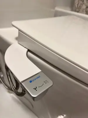 a close up of a toilet with a sign on it at Niagara Getaway across Fallsview in Niagara Falls