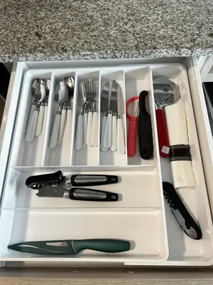 a white drawer filled with utensils on a counter at 1-bedroom condo near University of Waterloo in Waterloo