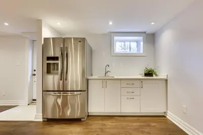 a kitchen with a stainless steel refrigerator and a sink at Luxurious and Spacious 4BR Home Near Downtown in Burlington