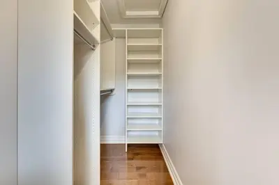 a hallway with white shelves in a white room at Luxurious and Spacious 4BR Home Near Downtown in Burlington