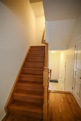 a hallway with a staircase in a house at Townhome Steps From Lake Ontario in Hamilton