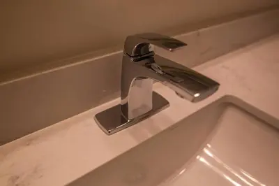 a bathroom sink with a faucet on a counter at Townhome Steps From Lake Ontario in Hamilton