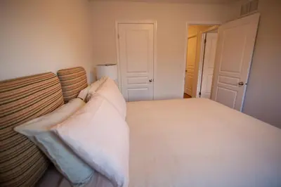 a bedroom with a bed with a pillow on it at Townhome Steps From Lake Ontario in Hamilton