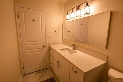 a bathroom with a sink and a mirror at Townhome Steps From Lake Ontario in Hamilton