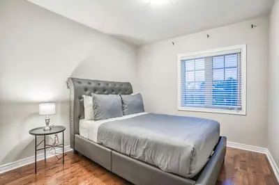 a bedroom with a bed and a window at Stylish 4BR Home 20 Mins from YYZ in Mississauga