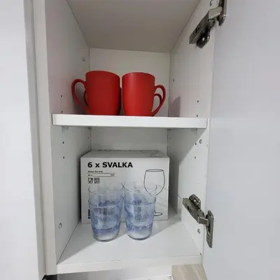 a cupboard with two cups and a box at Bright 2 Bedroom Basement Apartment in Angus in Angus