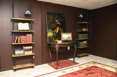a room with a desk with a painting on the wall at Cellar House NOTL - Entire Home in the Heart of Niagara-on-the-Lake in Niagara on the Lake