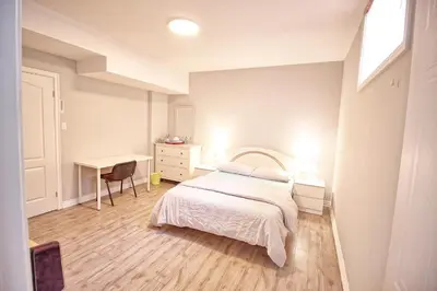 a small bedroom with a bed and a desk at Bright Basement & Private Bathroom, free Parking in Vaughan