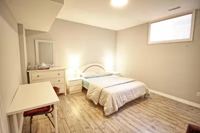 a bedroom with a bed and a desk and a window at Bright Basement & Private Bathroom, free Parking in Vaughan