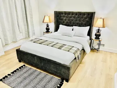 a bedroom with a large bed and two lamps at LaVida Exclusive Guest House, Free Parking (Rm#2) in London