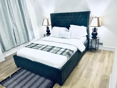 a bedroom with a blue bed with white sheets and pillows at LaVida Exclusive Guest House, Free Parking (Rm#2) in London