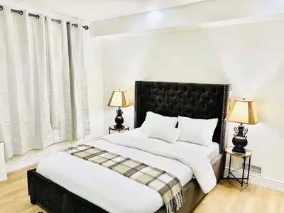 a bedroom with a large bed and two lamps at LaVida Exclusive Guest House, Free Parking (Rm#2) in London
