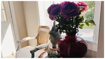 a vase with purple flowers sitting on a table at Cozy Place on Main Floor in Toronto