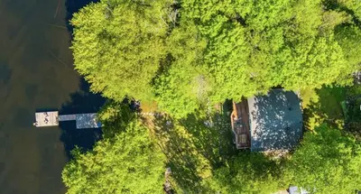 an overhead view of a house in the middle of trees at Waterfront Haliburton, All Season, Fully Equipped Cottage! in Haliburton
