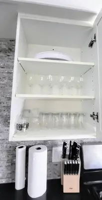 a white cabinet with some cups and glasses on it at Cozy Home in Niagara-on-the-Lake in Niagara on the Lake