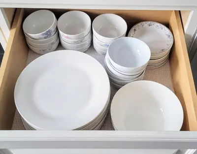 a drawer filled with white plates and bowls at Cozy Home in Niagara-on-the-Lake in Niagara on the Lake