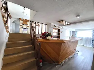 a staircase in a living room with a stair case at Cozy Home Close to Attractions in Niagara Falls in Thorold