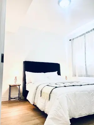 a white bedroom with a large bed and a window at LaVida Exclusive Guest House (Rm #3) in London