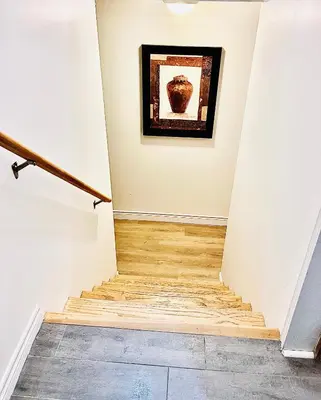 a hallway with a staircase with a painting on the wall at LaVida Exclusive Guest House (Rm #3) in London