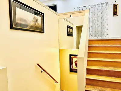 a staircase in a house with yellow walls at LaVida Exclusive Guest House (Rm #3) in London
