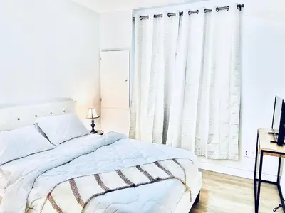 a white bedroom with a bed and a desk at LaVida Exclusive Guest House(Rm#4) in London