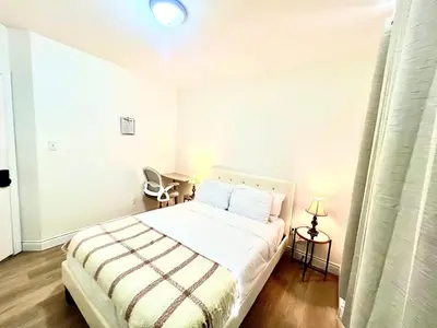 a bedroom with a bed and a chair in it at LaVida Exclusive Guest House(Rm#4) in London