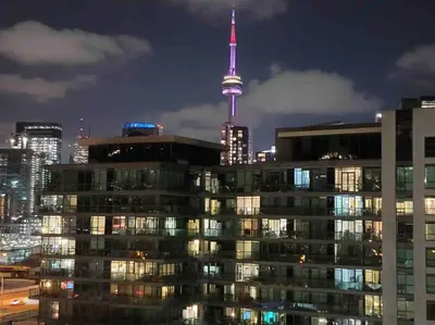 a view of the cn tower at night at Downtown Toronto Condo Parking Sleeps 4 Balcony Walk to Lake in Toronto