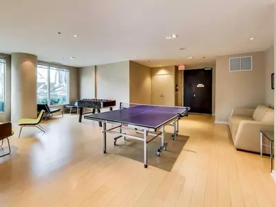 a room with a ping pong table and a couch at Downtown Toronto Condo Parking Sleeps 4 Balcony Walk to Lake in Toronto